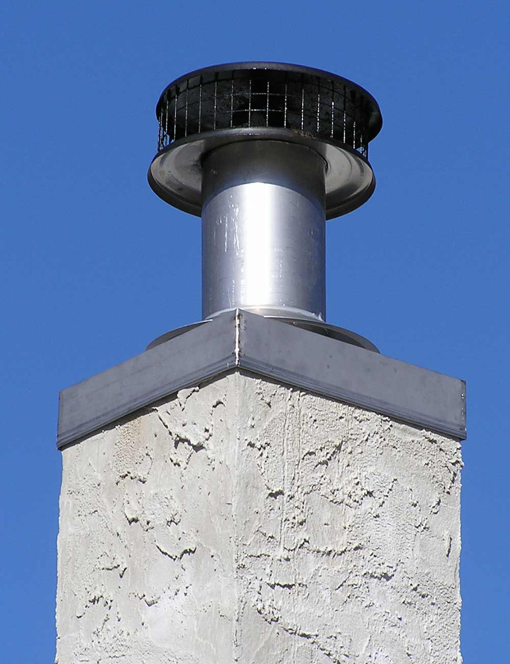 Close up of newly installed stainless steel chase cover and chimney cap