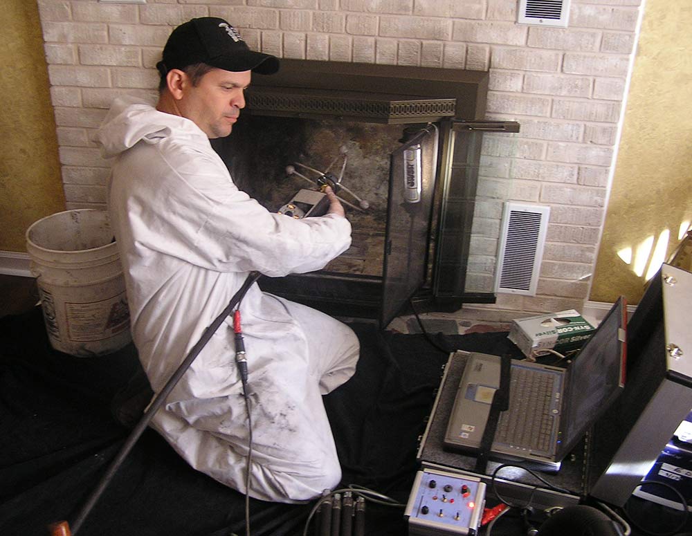 Mason's Chimney Service Original Photo of Chimney System Video Inspection technician performing chimney system video inspection through fireplace