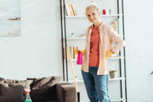 Woman spring cleaning her home in gloves