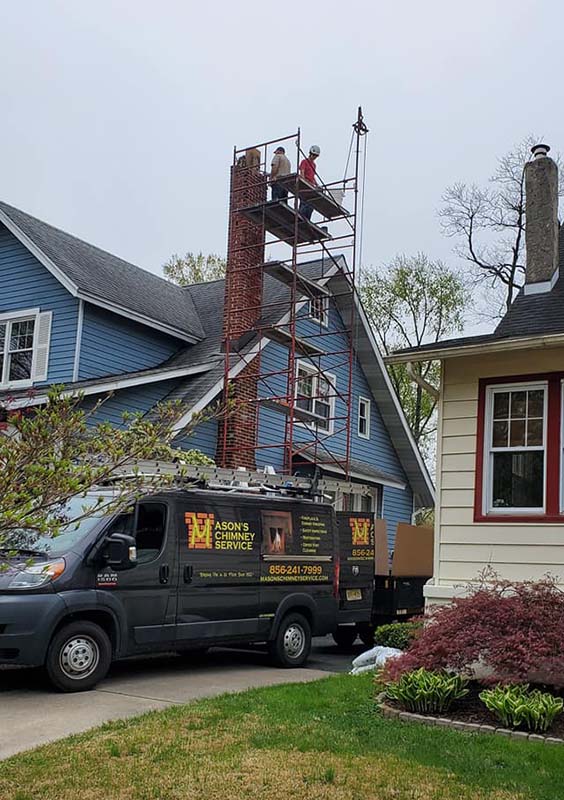 Techs on scaffolding over company van